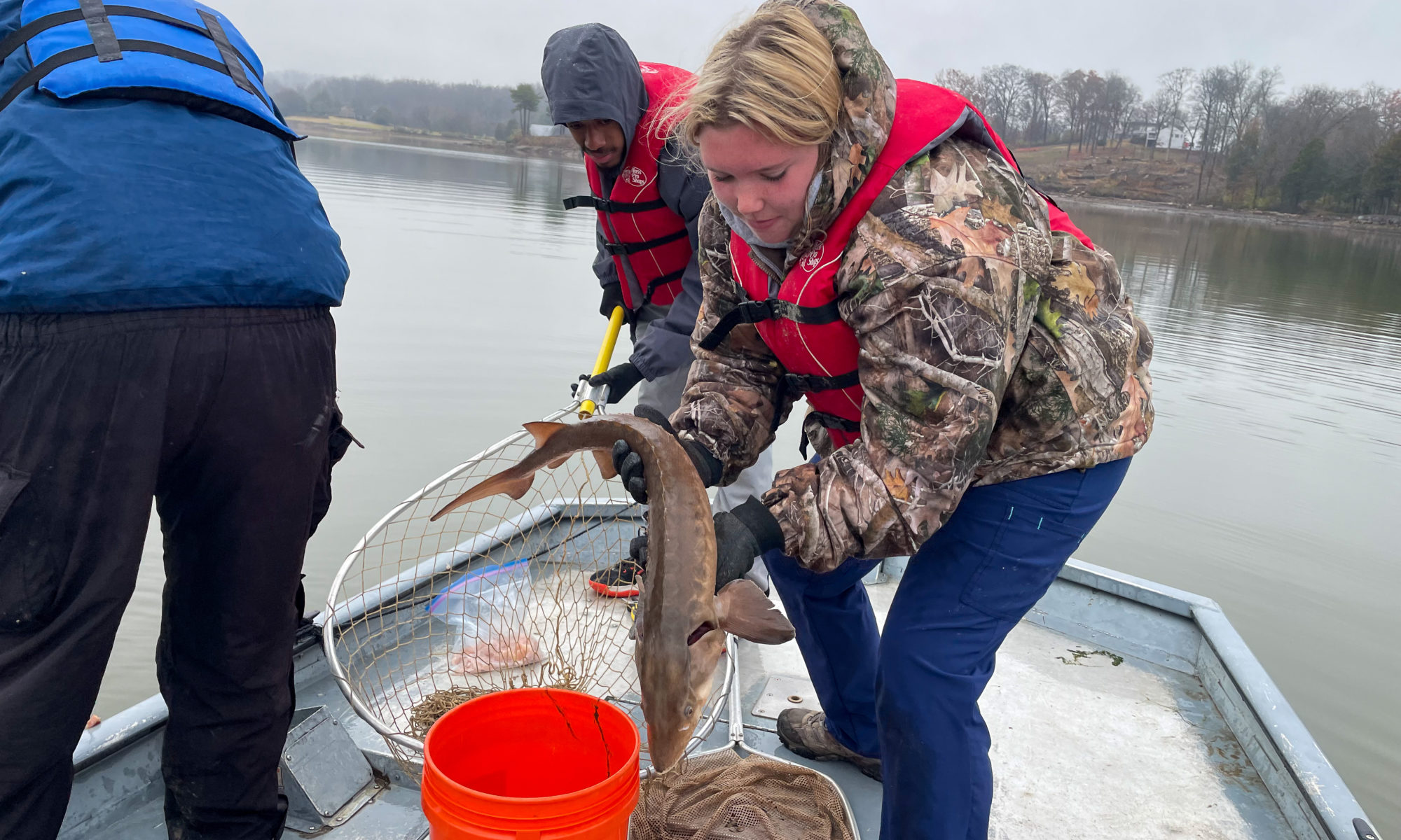 Student holds fish