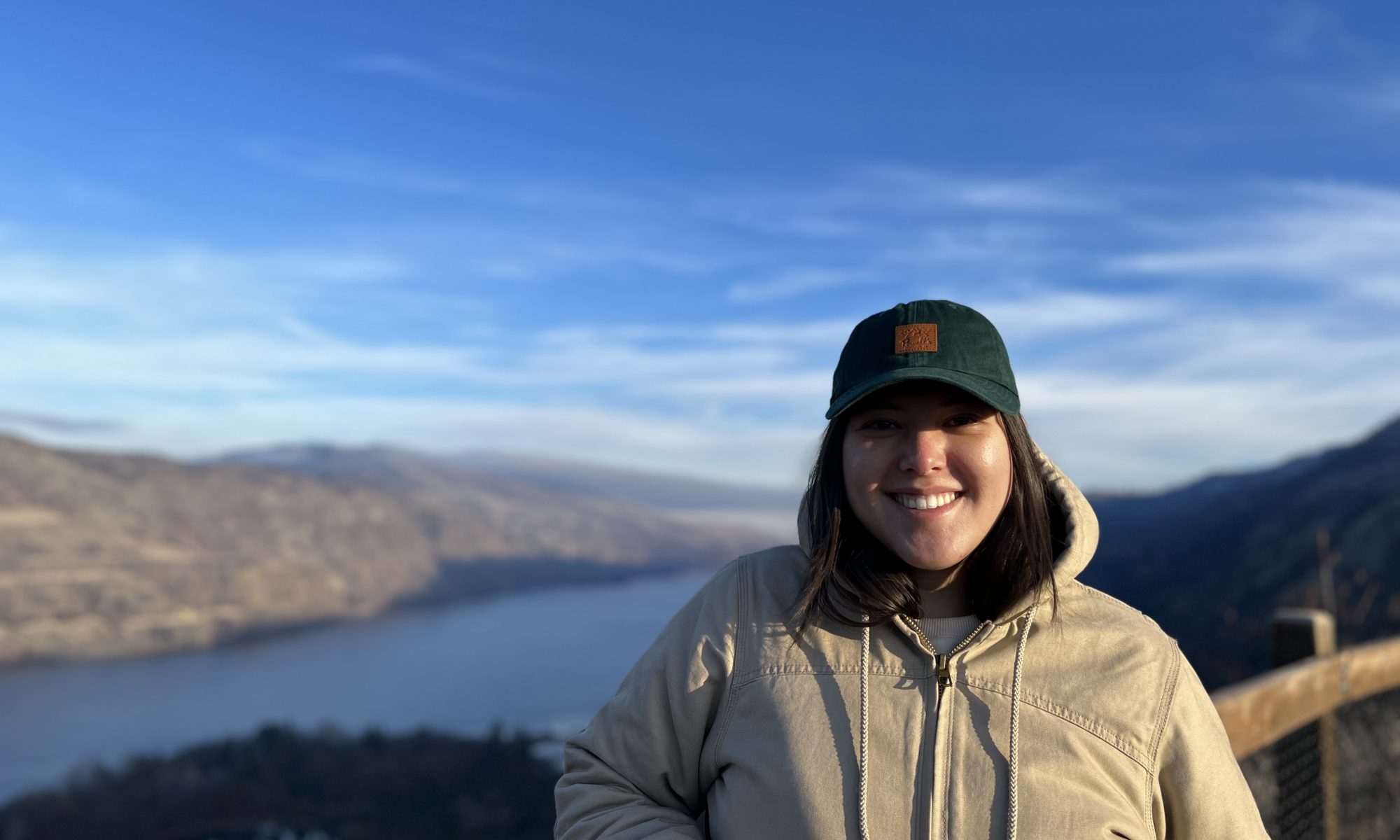 Woman stands on river overlook