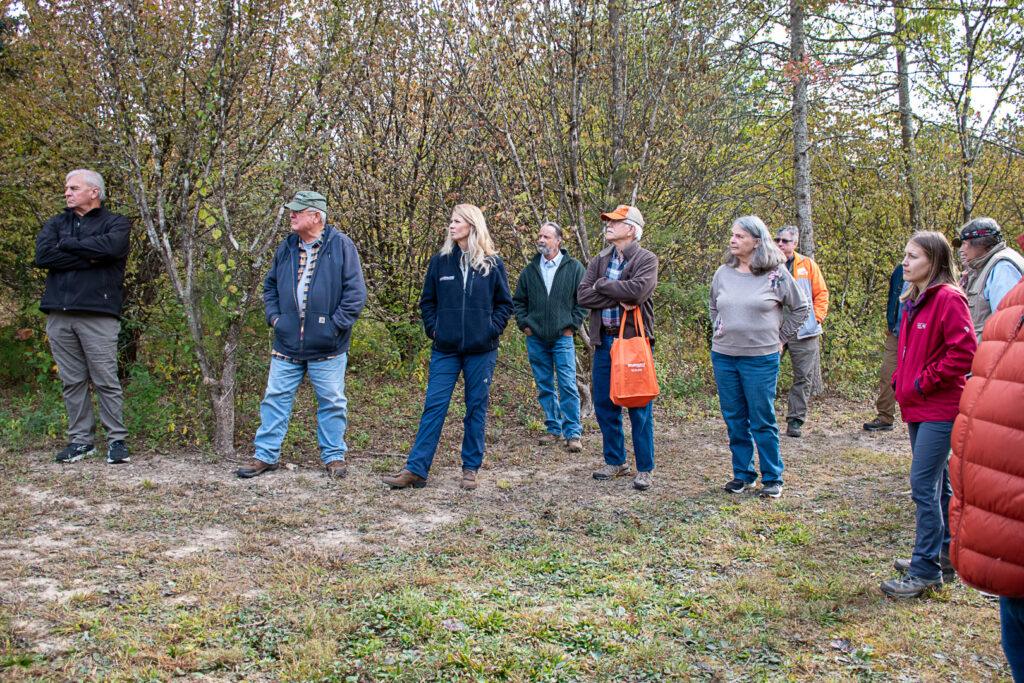 People listen to UT Tree Improvement Program Director Scott Schlarbaum talk about the Cornelia Cherry Project at the UT Arboretum during the 2023 Woods and Wildlife Field Day.