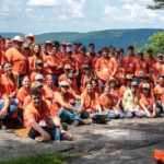 About thirty people pose for a group photo on an overlook in Bridgestone-Firestone Wildlife Management Area.