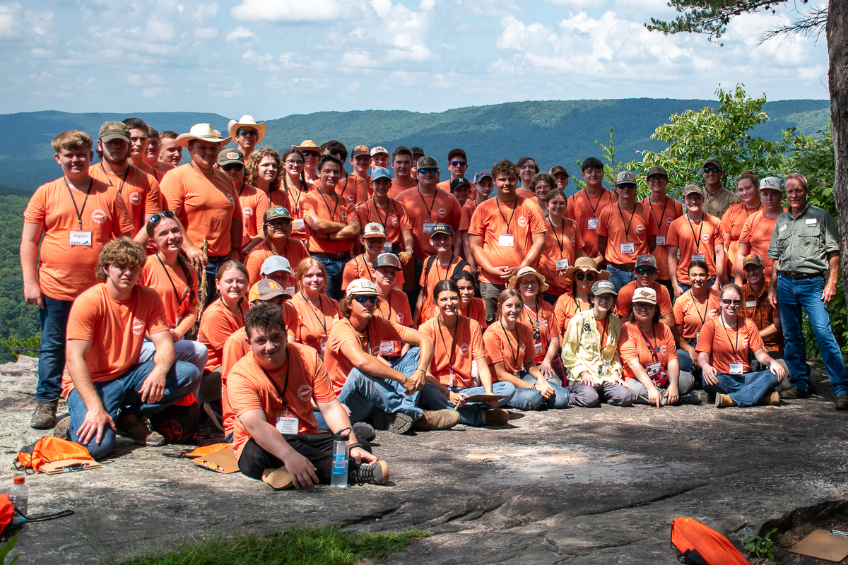 About thirty people pose for a group photo on an overlook in Bridgestone-Firestone Wildlife Management Area.