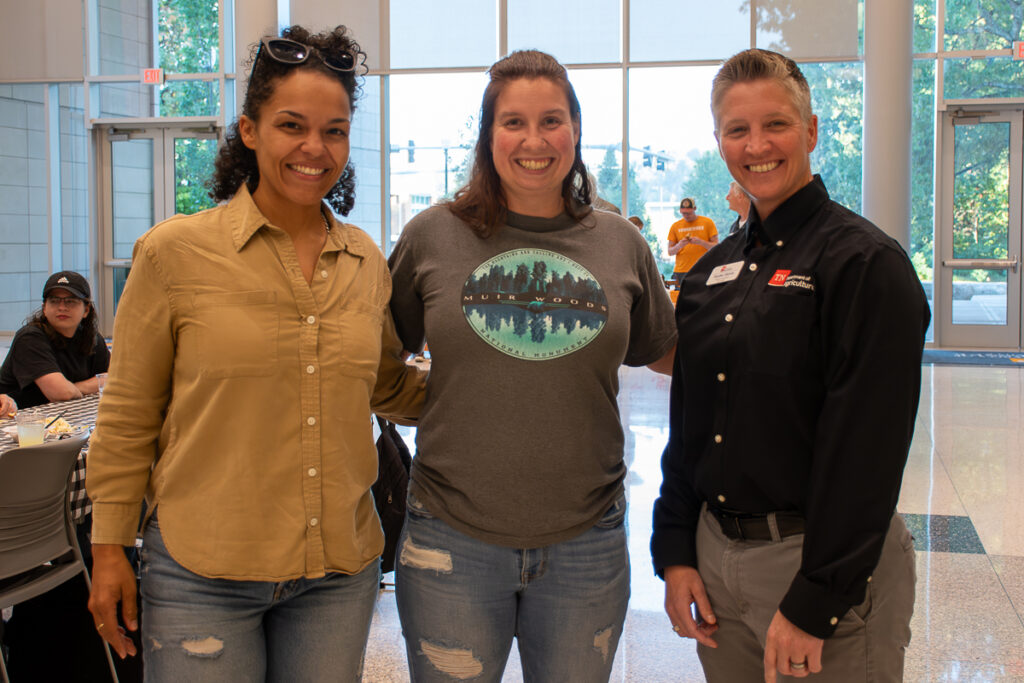 Three people pose together in a building on the UT Institute of Agriculture campus.