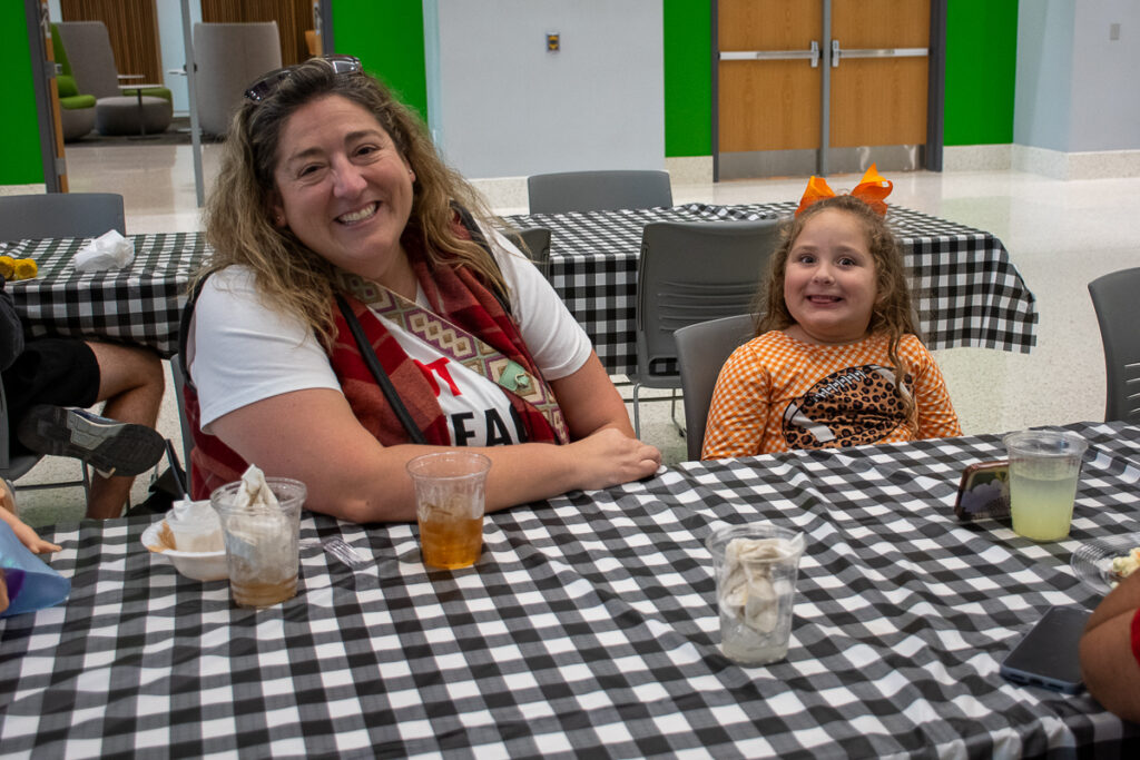 Two people pose at a table in a building on the UT Institute of Agriculture campus.