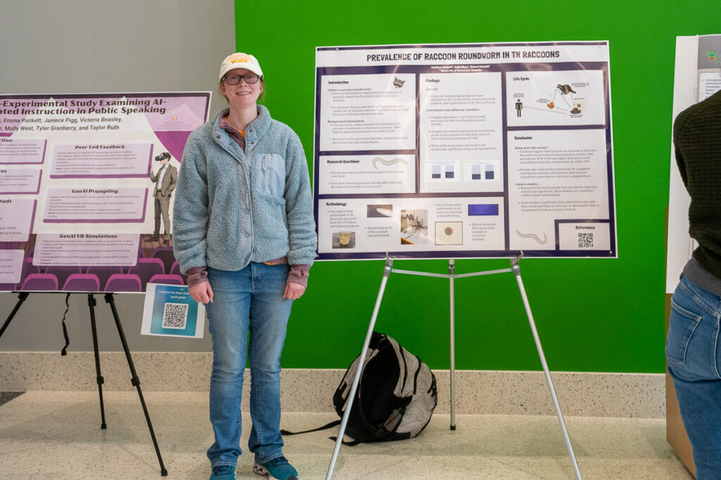 A person stands beside a poster in the Agriculture and Natural Resources Building at the UT Institute of Agriculture.