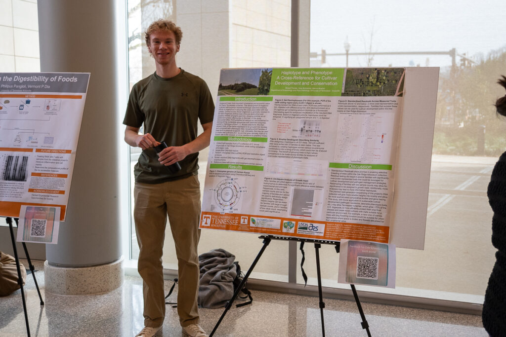A person stands next to a poster in the Agriculture and Natural Resources Building at the UT Institute of Agriculture.