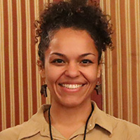 Person stands in front of a striped wall.