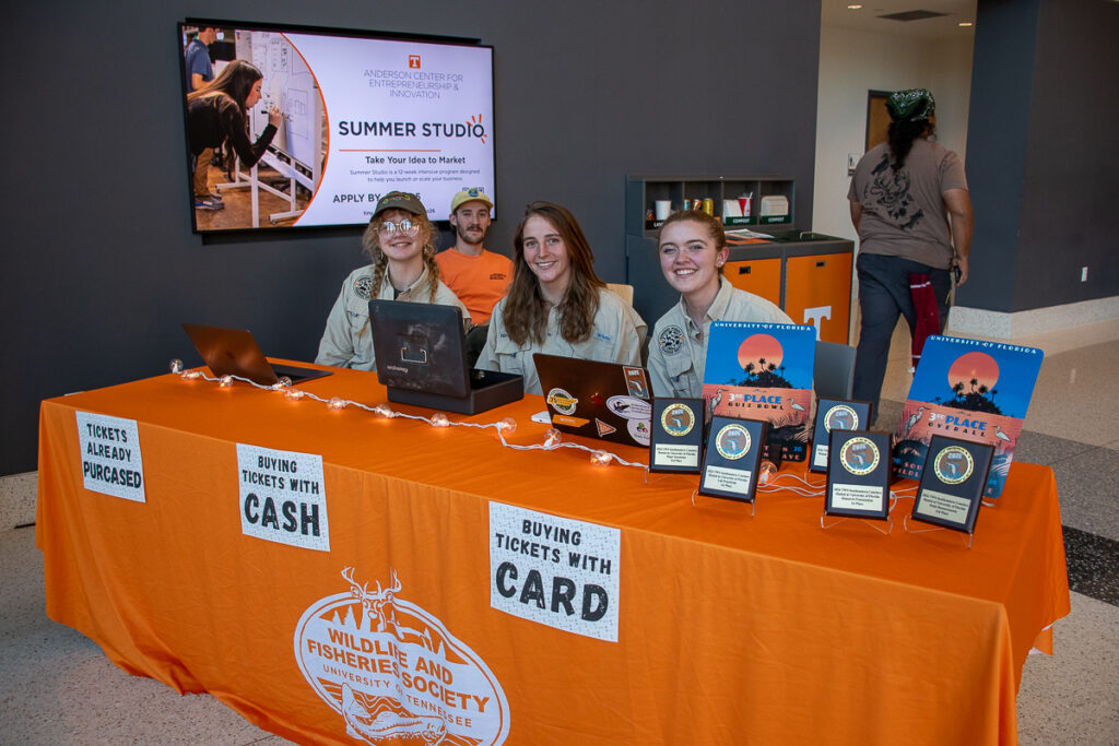 Four people sit behind a table in a building on the UT Institute of Agriculture campus.