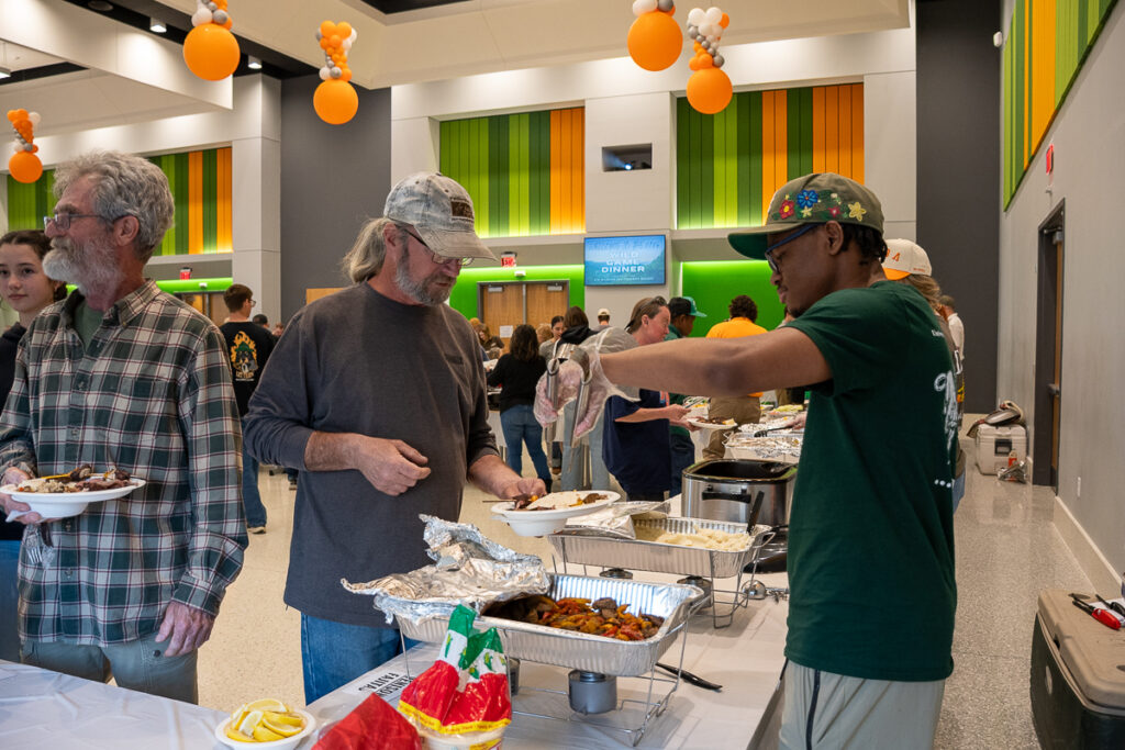One person serves another in a building on the UT Institute of Agriculture campus.