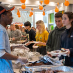 People walk through a buffet line while served by others at the UT Institute of Agriculture.