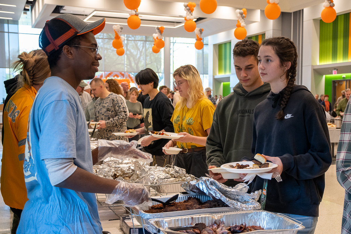 People walk through a buffet line while served by others at the UT Institute of Agriculture.