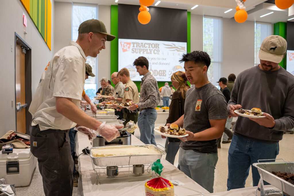 A person serves another in a buffet line in a building on the UT Institute of Agriculture campus.