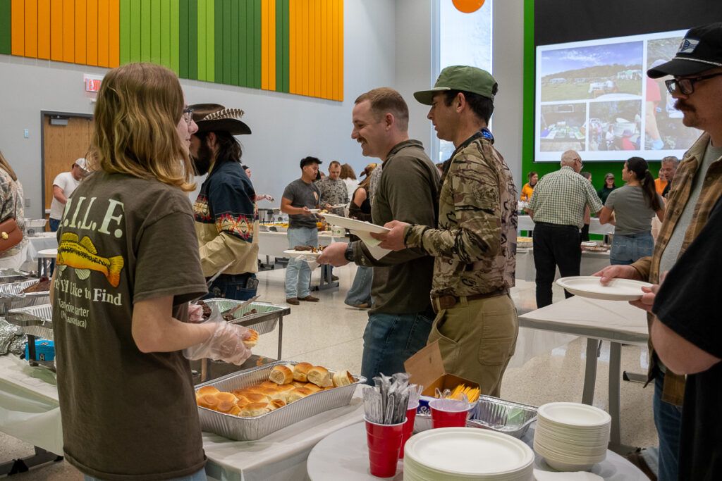 People stand in a buffet line in a building on the UT Institute of Agriculture campus.