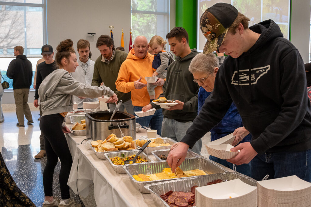 People stand in a buffet line in a building on the UT Institute of Agriculture campus.