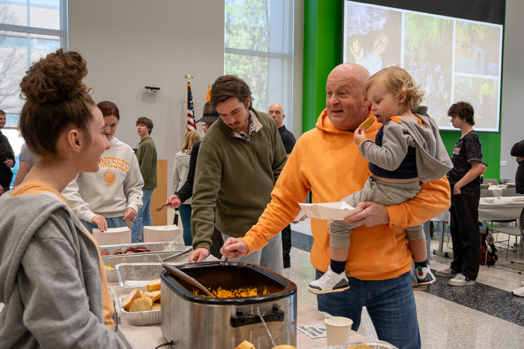 Two people talk in a buffet line in a building on the UT Institute of Agriculture campus.