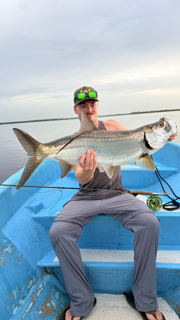 A person holding a fish.