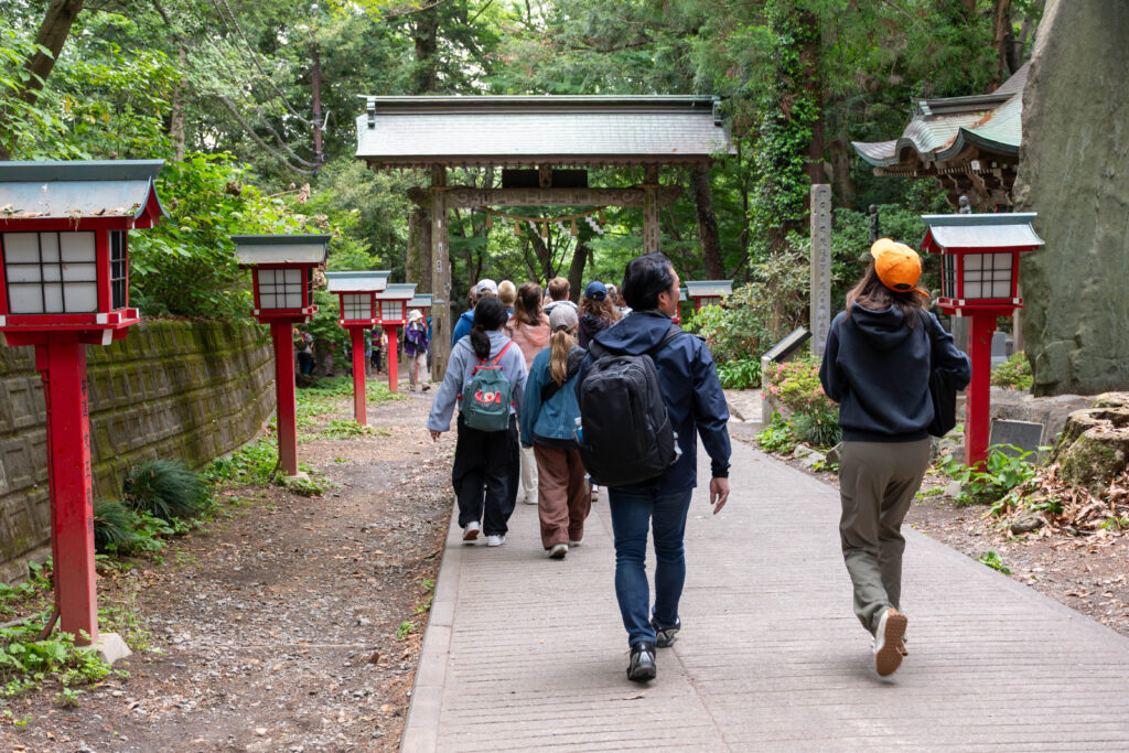 People walk down a path on Mt. Takao in Japan.