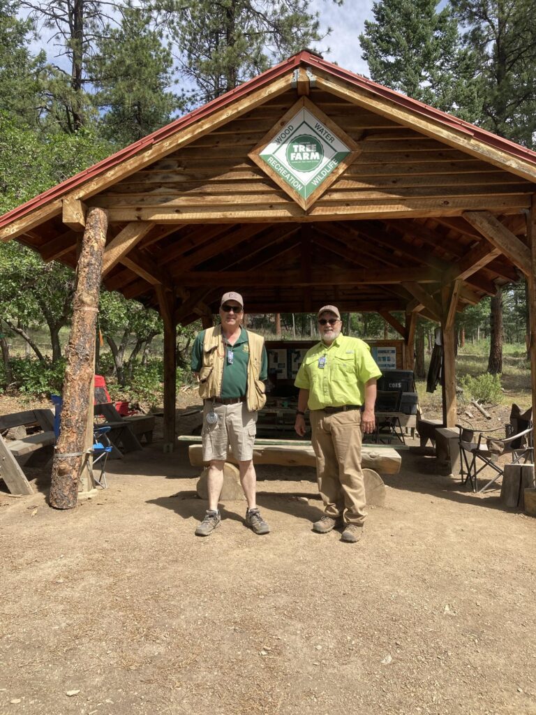 Two men stand under pavilion at Philmont Scout Ranch in New Mexico.