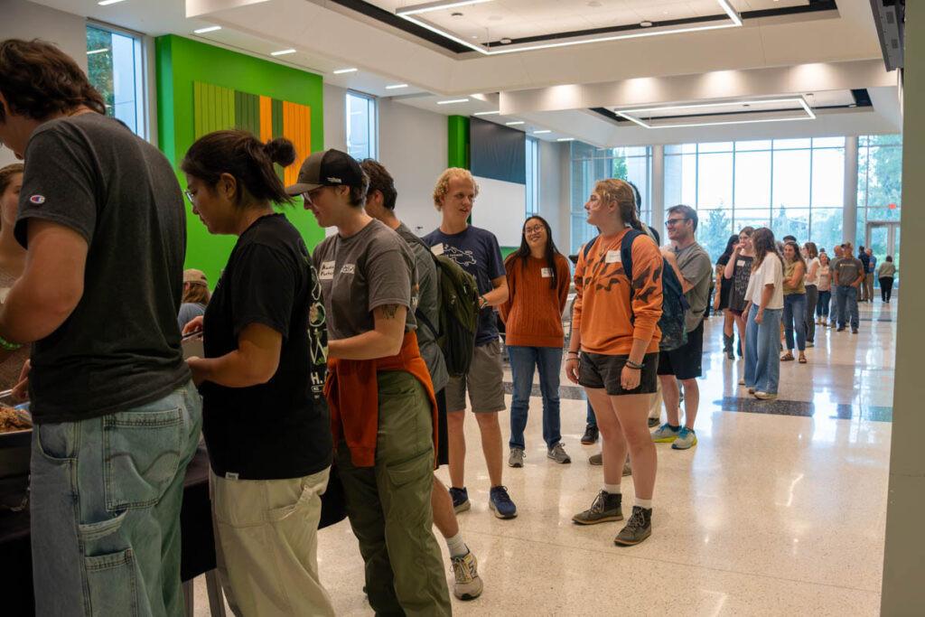 Several people line up in a buffet line in a building on the UT Institute of Agriculture campus.