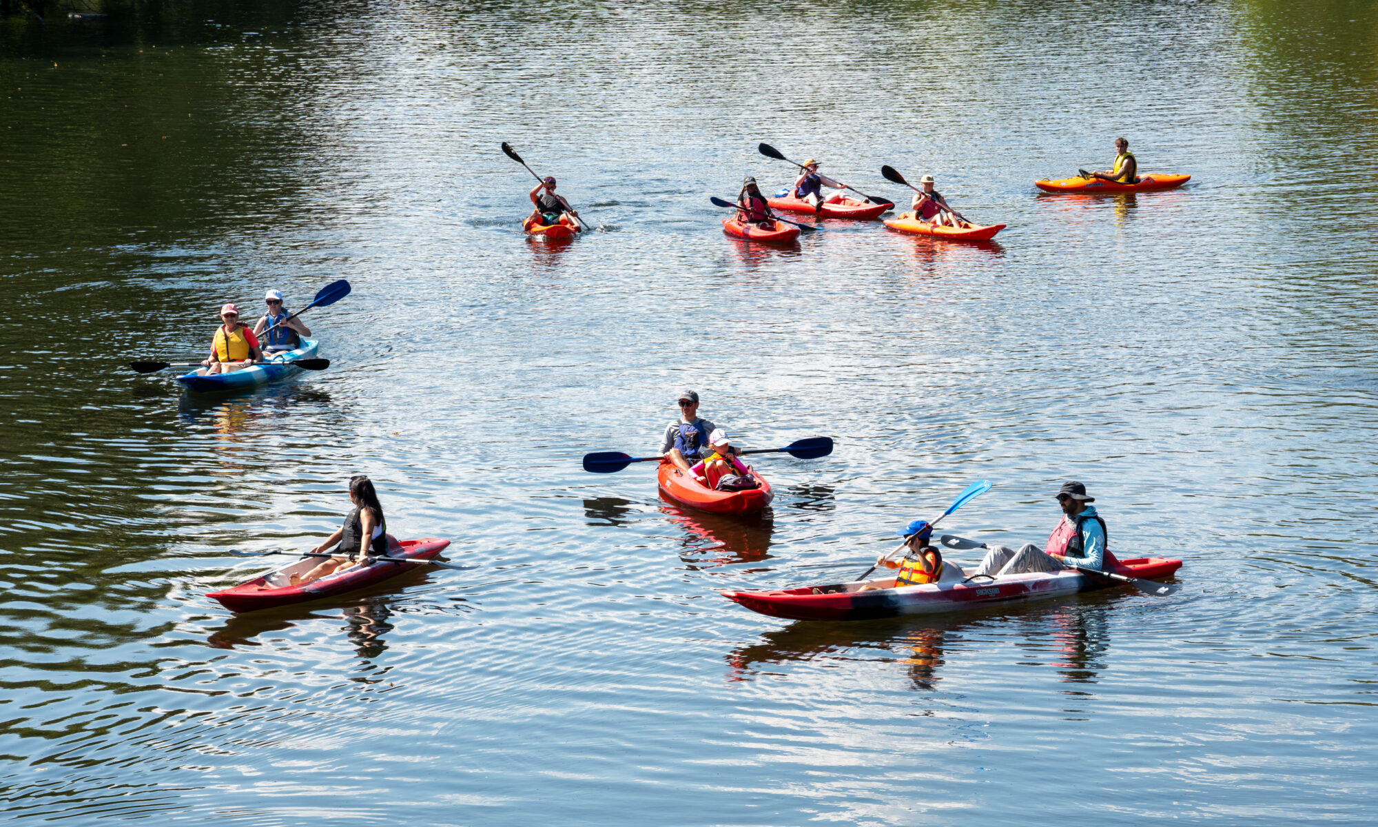 Twelve people kayak on the Little River in Maryville.